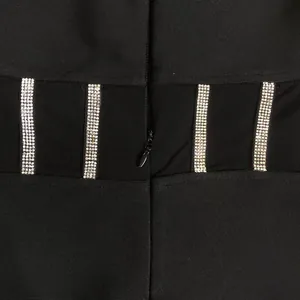 Close-up detail of silver rhinestones and invisible zipper on black mesh bandage dress