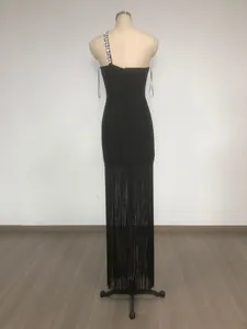 Back view of black one-shoulder bandage dress with rhinestone chain and long fringe