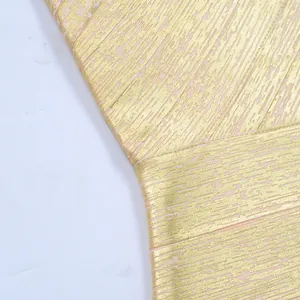 Close-up macro view showing the exquisite metallic gold foil texture on the pink bandage dress fabric