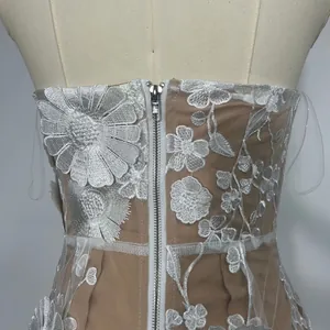 Detailed view of floral embroidery and zipper on a strapless banquet evening dress