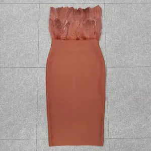 Detailed view of rust orange bandage dress featuring elegant ostrich feather trim