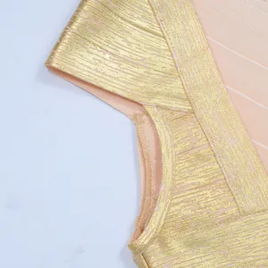 Detailed close-up of a gold foil bandage dress showing shoulder and fabric texture.