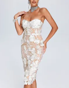 Close-up of elegant white strapless dress with 3D lace flowers and embroidery.