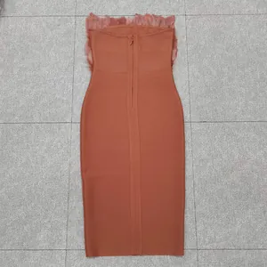 Back view detail of terracotta tube bodycon bandage dress with elegant ostrich feather trim