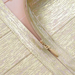 Close-up detail of the concealed zipper on a premium golden metallic foil bandage bodycon dress