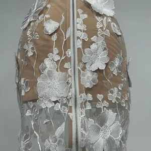 Detail of white 3D floral embroidery on elegant mesh strapless maxi evening gown