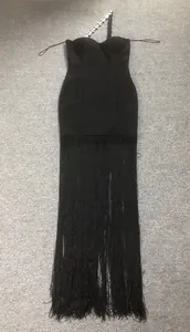 Elegant black bandage evening dress with long fringe hem and sparkling rhinestone strap.