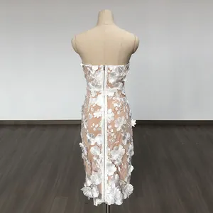 Detail view of white strapless bodycon dress with 3D floral lace and back zipper
