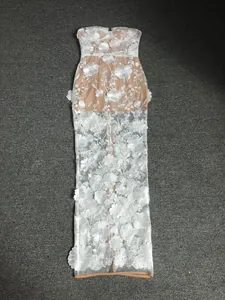 Detailed full-length view of a white 3D floral lace strapless dress with nude lining