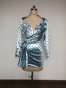 Detailed view of light blue polka dot satin dress with deep V-neck and 3D floral decor