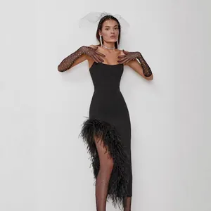 Elegant black strapless evening dress with ostrich feather trim and irregular split detail