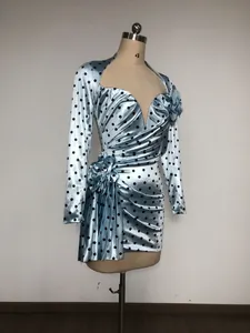 Detail view of light blue polka dot dress with 3D flower and pleated waist on mannequin