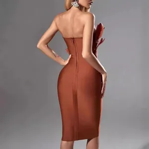 Elegant rust red strapless bandage midi dress with ostrich feather detail for parties.