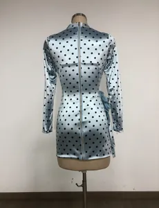 Detailed back view of an elegant light blue polka dot mini dress with long sleeves and zipper