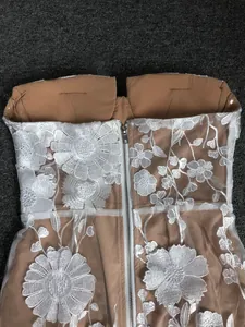 Detailed back view of strapless banquet dress featuring 3D white floral embroidery
