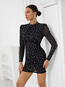 Full view of elegant black mesh long sleeve mini dress decorated with rhinestones