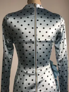 Detailed view of blue polka dot satin dress with back zipper and 3D floral decoration