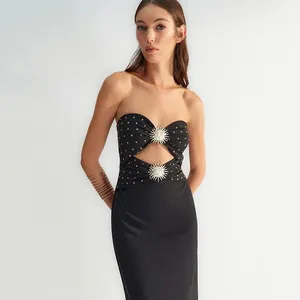Elegant black strapless bandage dress featuring sunburst metal accents and gold rhinestones