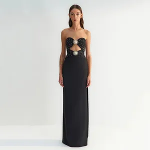 Elegant black strapless maxi dress with sunburst metal accents and rhinestone detail