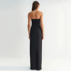 Back view of elegant black strapless slim-fit maxi bandage dress with metallic accents.