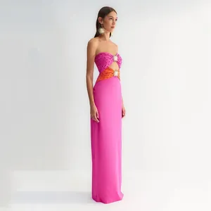 Elegant strapless pink maxi dress with rhinestone sun accessories and cutout details.