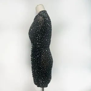 Side view detail of black mesh long sleeve bodycon dress with rhinestone embellishments