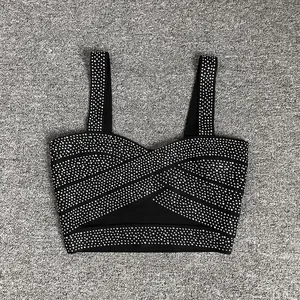 Detailed macro shot of a black rhinestone-embellished bandage crop top with sexy straps