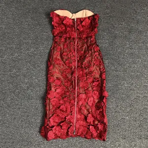 Close-up of elegant red evening gown featuring 3D floral lace appliqués and back zipper