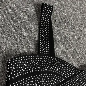 Close-up of black bandage crop top strap featuring sparkling silver rhinestone details