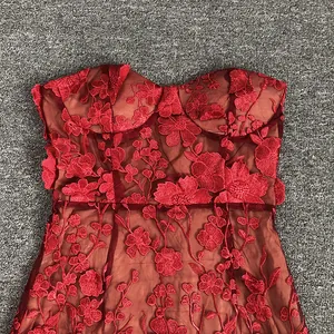 Detailed view of exquisite 3D red lace flower embroidery on elegant evening gown