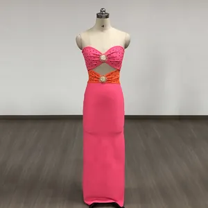 Detail view of pink and orange bandage dress with metal sunburst accessories.