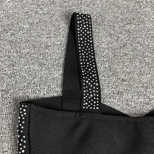 High-quality close-up of shimmering rhinestones on a stylish black bandage strap top