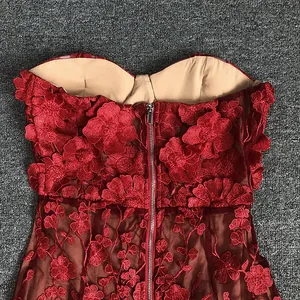 Close-up of back zipper and 3D floral lace embroidery on elegant red bodice.