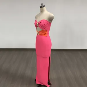 Side view of elegant pink and orange strapless bandage dress with rhinestone details