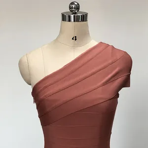 Detailed close-up view of a terracotta one-shoulder bandage bodycon dress on a mannequin.