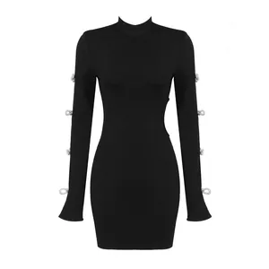 Elegant black long sleeve mini dress featuring rhinestone bows and stylish side cut-outs.