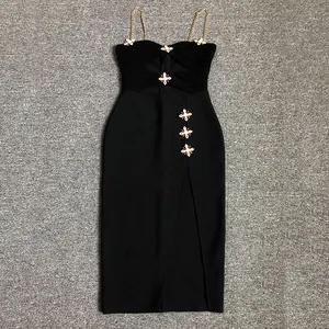 Detail view of sexy black bandage dress featuring rhinestone cross accents and gold chain straps