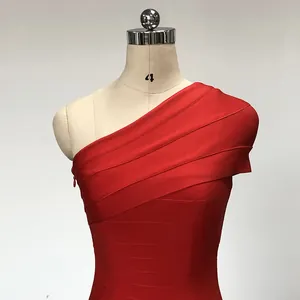 Detailed view of an elegant red one-shoulder bodycon bandage dress on a studio mannequin