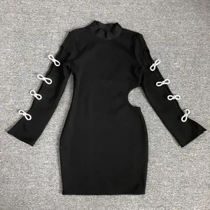 Detailed view of black ribbed mini dress with side cutout and white bow sleeve accents.