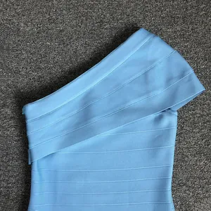 Close-up detail of a light blue one-shoulder bandage dress showing fabric texture.