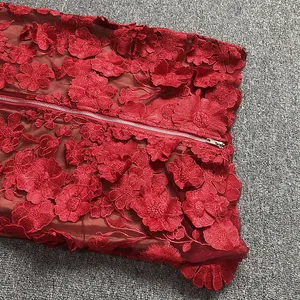Close-up of red 3D floral embroidery lace dress with metal zipper detail