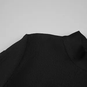 Close-up of the collar and ribbed fabric texture on a black long sleeve mini dress