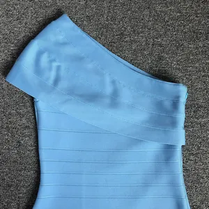Detail shot of the light blue one-shoulder bandage dress showing the fabric texture.