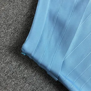 Detail view of light blue bandage dress showing ribbed fabric texture and matching zipper.