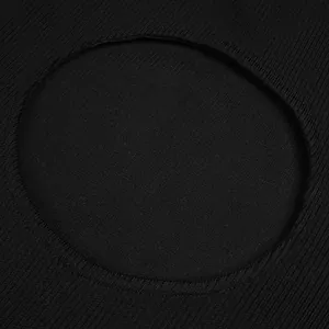 Macro detail of the circular cutout and ribbed knit texture on a black bandage dress