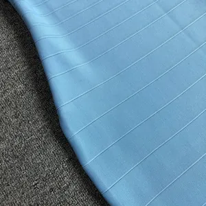 Macro detail of light blue ribbed bandage fabric showing high-quality elastic material texture.