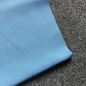 Close-up detail of the premium ribbed bandage fabric in a vibrant light blue shade.