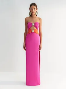 Elegant fuchsia strapless long dress featuring sun-shaped metal accents and cutout design