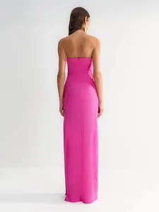 Elegant strapless hot pink maxi dress with slim fit design and back zipper closure.