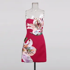 Close-up of elegant magenta dress showing intricate large floral embroidery details.